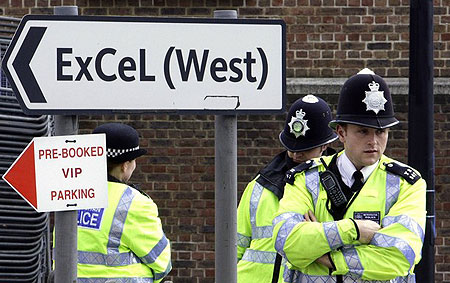 Police officers stand next to a sign near the ExCeL centre in London March 31, 2009.